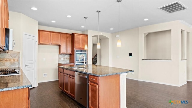 647 Ridgeglen Dr, New Braunfels, TX 78130 - kitchen featuring appliances with stainless steel finishes, arched walkways, dark wood-type flooring, tasteful backsplash, and recessed lighting