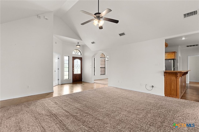 2301 Big Divide Rd, Copperas Cove, TX 76522 - unfurnished living room with high vaulted ceiling, a ceiling fan, arched walkways, baseboards, and light carpet
