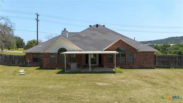 2301 Big Divide Rd, Copperas Cove, TX 76522 - rear view of property with brick siding, a patio area, a chimney, and a shingled roof