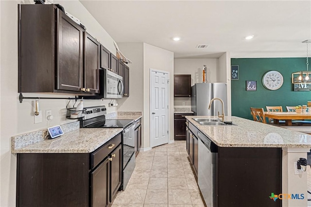 kitchen featuring dark brown cabinets, visible vents, a sink, and appliances with stainless steel finishes