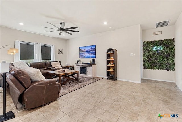 living room with light tile patterned floors, a ceiling fan, visible vents, and recessed lighting