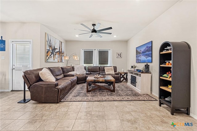 living room featuring baseboards, a ceiling fan, light tile patterned flooring, and recessed lighting