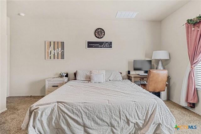 carpeted bedroom featuring visible vents and baseboards