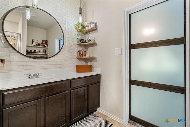 bathroom with backsplash, baseboards, and vanity