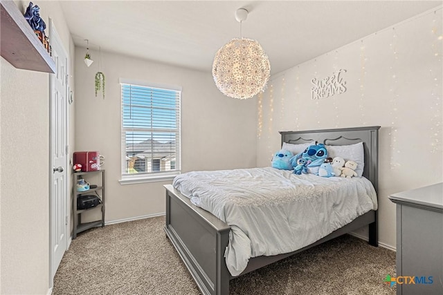 bedroom with baseboards and carpet