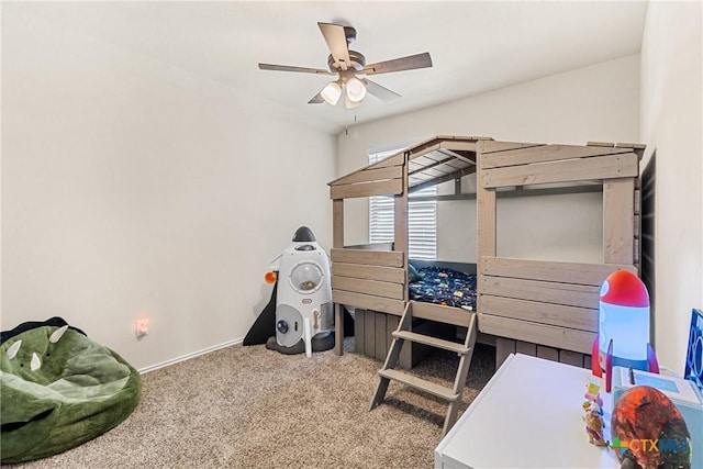 carpeted bedroom with a ceiling fan and baseboards