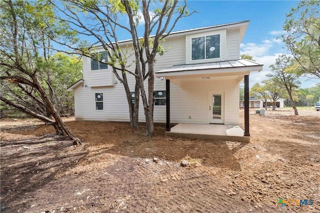 back of property with a patio