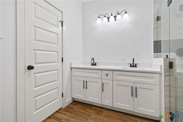 bathroom with vanity and a shower with shower door