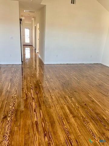 spare room with dark hardwood / wood-style flooring