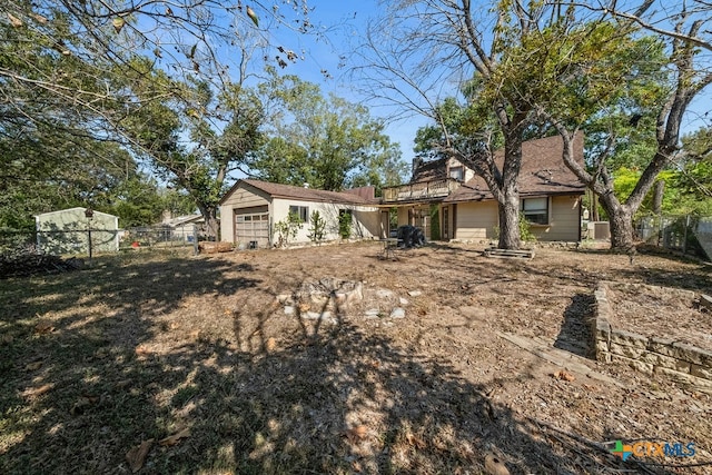 rear view of property featuring a garage