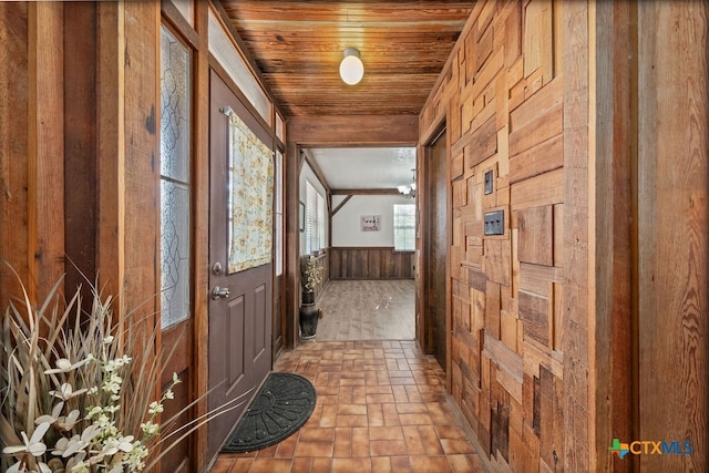 entryway featuring wood walls and wooden ceiling