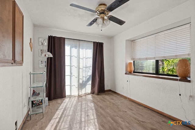 empty room featuring light hardwood / wood-style flooring and ceiling fan