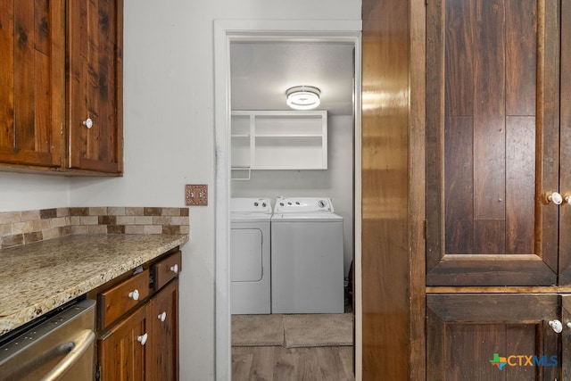 clothes washing area featuring independent washer and dryer and wood-type flooring