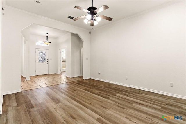 interior space featuring ceiling fan, hardwood / wood-style floors, and crown molding