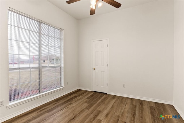 empty room featuring ceiling fan and dark hardwood / wood-style flooring