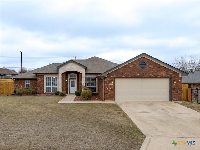 single story home with a garage and a front lawn