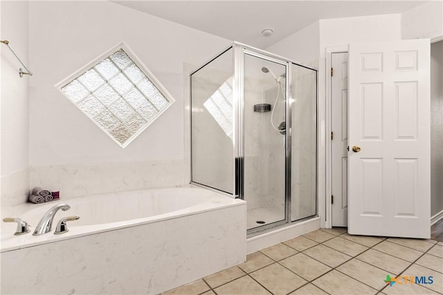 bathroom featuring tile patterned floors and shower with separate bathtub