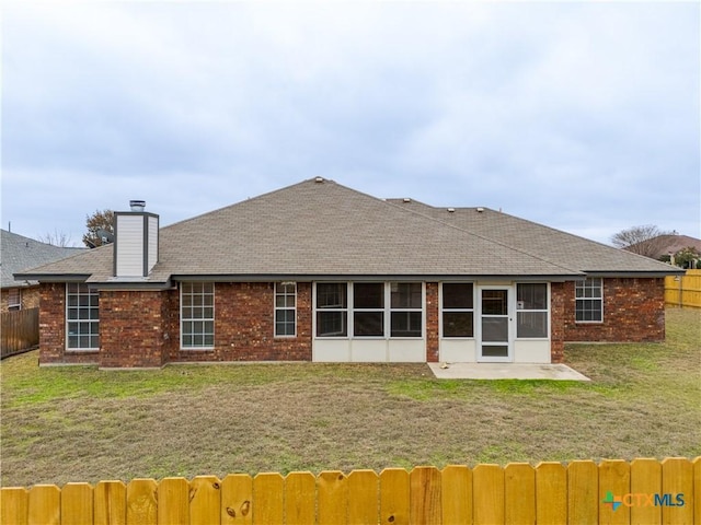 rear view of property with a lawn