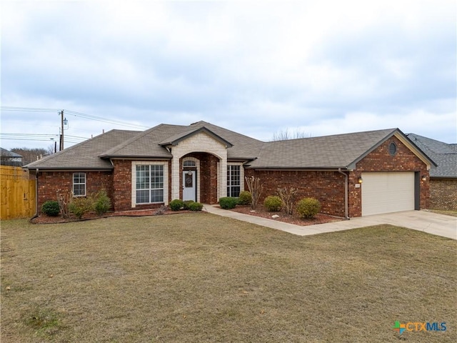 single story home with a garage and a front lawn