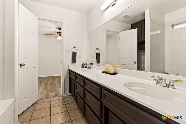 bathroom featuring tile patterned flooring, vanity, and ceiling fan