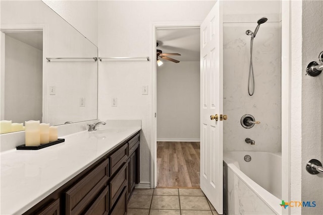 bathroom featuring vanity, tile patterned floors, tiled shower / bath, and ceiling fan