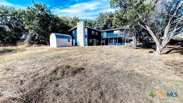 2011 Valley Oaks Dr, Harker Heights, TX 76548 - rear view of house featuring a shed, a deck, and a chimney