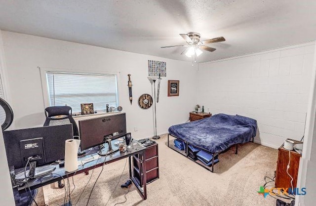 carpeted bedroom with ceiling fan and a textured ceiling