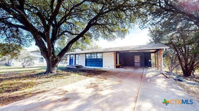 ranch-style house featuring a carport