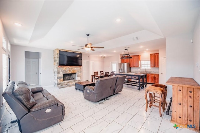 living room featuring visible vents, a fireplace, a ceiling fan, and recessed lighting