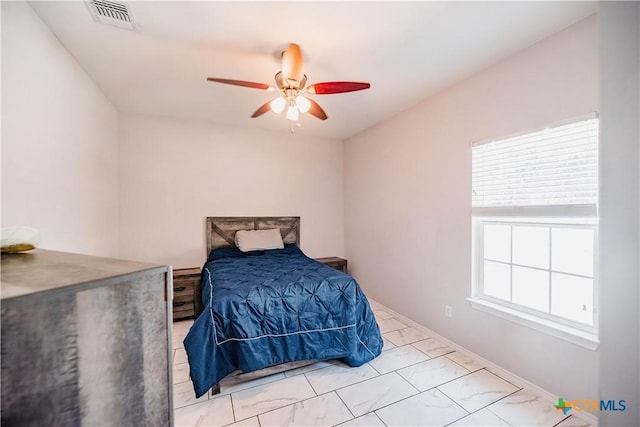 bedroom with marble finish floor, visible vents, and ceiling fan