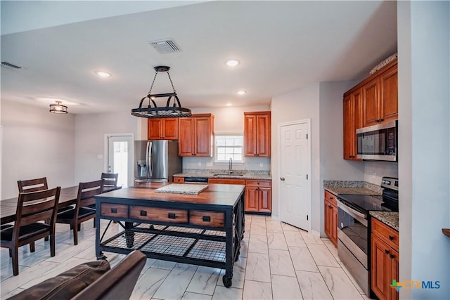 kitchen with marble finish floor, appliances with stainless steel finishes, a sink, and visible vents