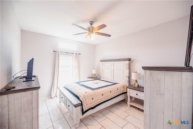 bedroom with marble finish floor and a ceiling fan