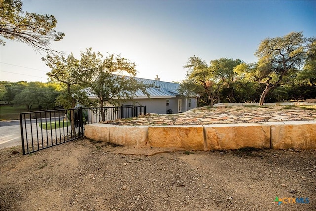 view of front of house with a gate and metal roof