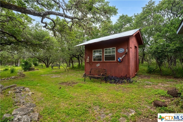 view of outdoor structure with a lawn