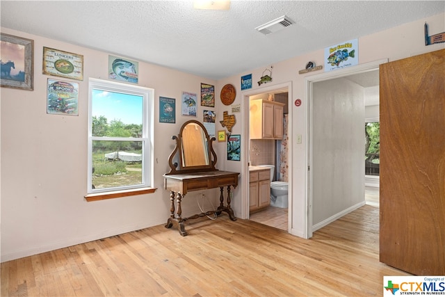 miscellaneous room featuring light hardwood / wood-style floors and a textured ceiling