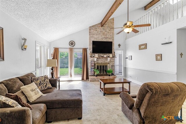 205 Magdalena Dr, Victoria, TX 77904 - living area featuring beam ceiling, a fireplace, ceiling fan, high vaulted ceiling, and a textured ceiling