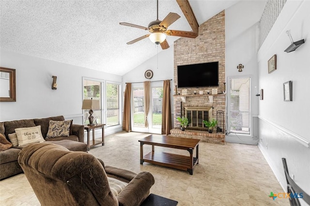 205 Magdalena Dr, Victoria, TX 77904 - living area featuring ceiling fan, beam ceiling, a brick fireplace, a textured ceiling, and high vaulted ceiling