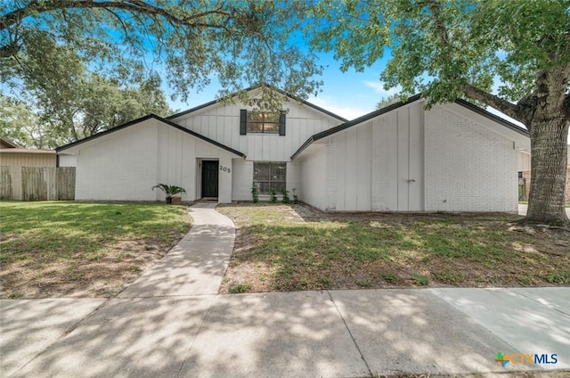205 Magdalena Dr, Victoria, TX 77904 - view of front of property featuring brick siding, a front lawn, and fence
