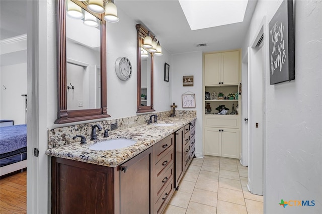 205 Magdalena Dr, Victoria, TX 77904 - ensuite bathroom featuring visible vents, a sink, double vanity, and a skylight