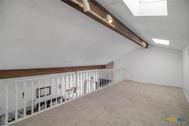 205 Magdalena Dr, Victoria, TX 77904 - additional living space featuring carpet floors, baseboards, lofted ceiling with skylight, and a textured ceiling