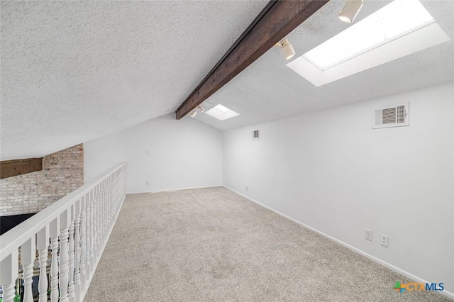 205 Magdalena Dr, Victoria, TX 77904 - bonus room featuring vaulted ceiling with skylight, carpet floors, baseboards, and visible vents