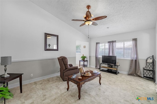 205 Magdalena Dr, Victoria, TX 77904 - living area featuring a textured ceiling, tile patterned floors, a ceiling fan, baseboards, and vaulted ceiling