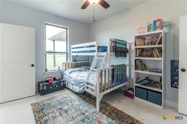 bedroom featuring marble finish floor, ceiling fan, and baseboards