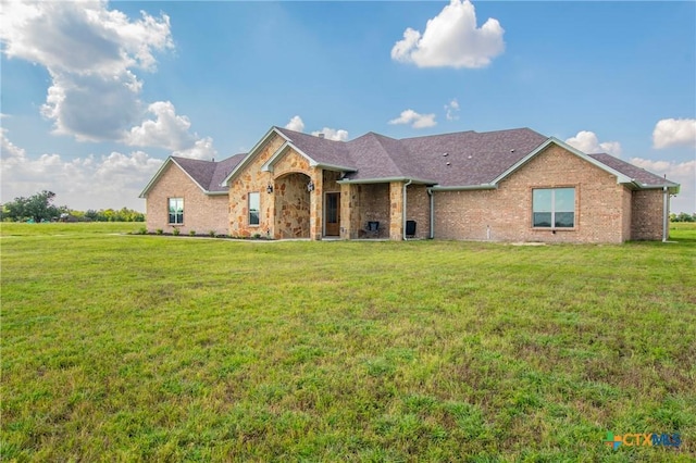 single story home with a front lawn and brick siding