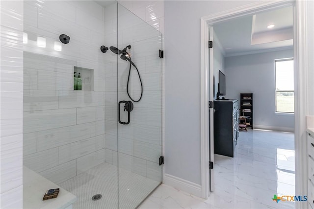 bathroom with a stall shower, baseboards, marble finish floor, and crown molding