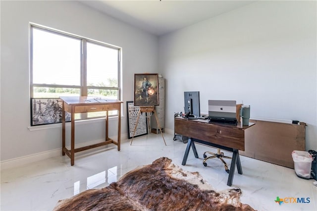 office space with marble finish floor and baseboards