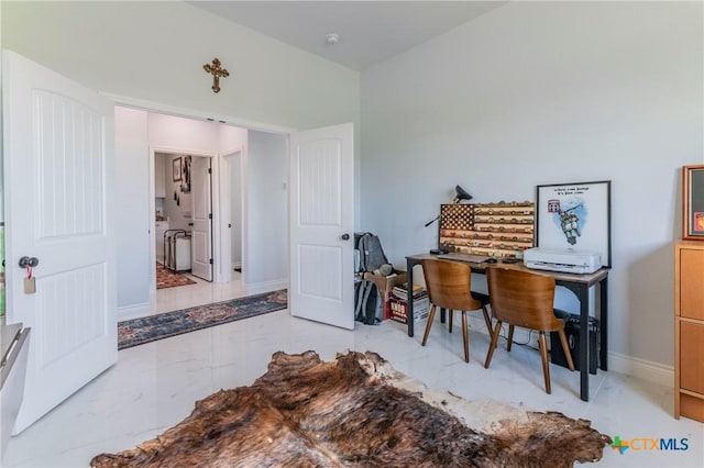 office space with marble finish floor and baseboards