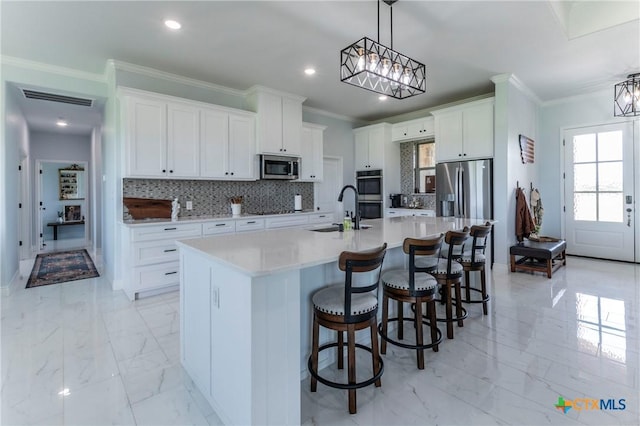 kitchen featuring visible vents, appliances with stainless steel finishes, marble finish floor, crown molding, and backsplash