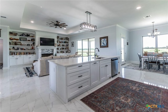 kitchen featuring visible vents, dishwasher, marble finish floor, crown molding, and a sink