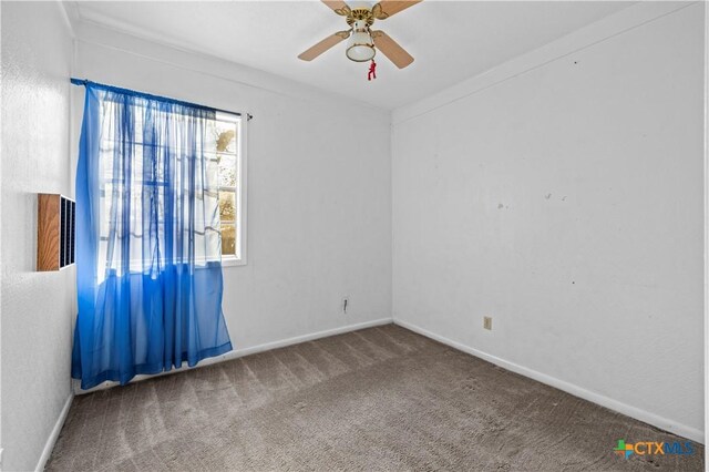 unfurnished room featuring ceiling fan and carpet